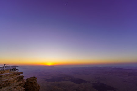Sunrise view of Makhtesh (crater) Ramon, with the moon, in the Negev Desert, Southern Israel. It is a geological landform of a large erosion cirqueの写真素材