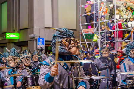 Lucerne, Switzerland - February 21, 2023: Band of musicians in costumes march in the streets, part of the final night parade of the Fasnacht Carnival, in Lucerne (Luzern), Switzerlandのeditorial素材