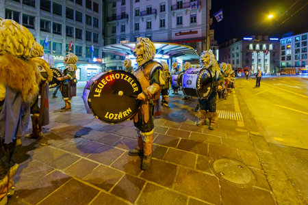 Lucerne, Switzerland - February 20, 2023: Band of musicians in costumes march in the streets, part of an early morning parade of the Fasnacht Carnival, in Lucerne (Luzern), Switzerlandのeditorial素材