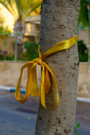 Haifa, Israel - October 26, 2023: Yellow ribbons on trees, as a symbolic call to bring back the people kidnapped to Gaza. Haifa, Israelのeditorial素材
