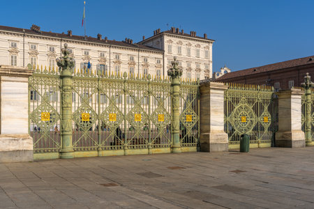 Turin, Italy - February 25, 2022: View of the Royal Palace entrance, and decorated fence, with visitors, in Turin, Piedmont, Northern Italyのeditorial素材