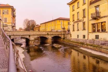 Monza, Italy - February 24, 2022: Sunset view of the Ponte dei Leoni (Lion bridge), with locals and visitors, in Monza, Lombardy, Northern Italyのeditorial素材