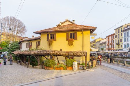 Milan, Italy - March 02, 2022: View of the Naviglio Grande canal, with locals and visitors, in Navigli, Milan, Lombardy, Northern Italyのeditorial素材