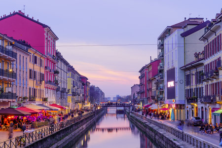 Milan, Italy - March 02, 2022: Evening view of the Naviglio Grande canal, with locals and visitors, in Navigli, Milan, Lombardy, Northern Italyのeditorial素材