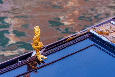 View of a typical golden lion on a gondola, in Venice, Veneto, Northern Italyの写真素材