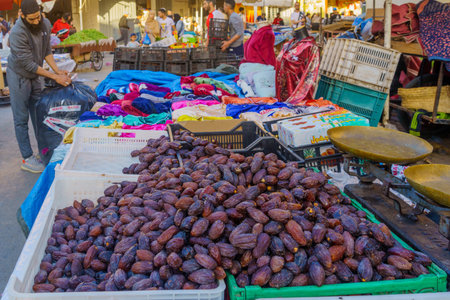 Meknes, Morocco - March 30, 2023: Street scene with market stalls, sellers, and visitors, in the market of Meknes, Moroccoのeditorial素材