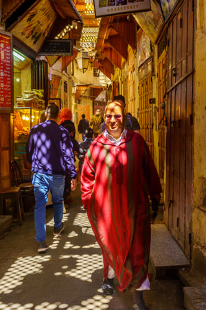 Fes, Morocco - March 31, 2023: View of an alley with locals and shadows patterns, in the old Medina of Fes, Moroccoのeditorial素材