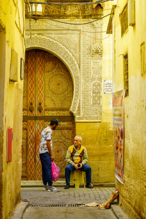 Fes, Morocco - March 31, 2023: View of an alley with locals, in the old Medina of Fes, Moroccoのeditorial素材