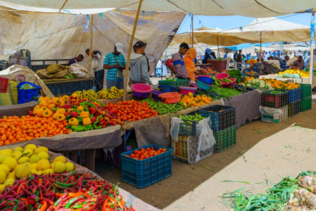 Rissani, Morocco - April 02, 2023: Market scene, with vegetable stalls, sellers, and shoppers, in Rissani, Sahara Desert, Moroccoのeditorial素材