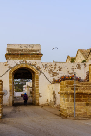 Essaouira, Morocco - April 06, 2023: View of the fishing port gate, with locals and visitors, in Essaouira (Mogador), Moroccoのeditorial素材