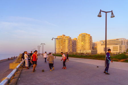 Casablanca, Morocco - March 29, 2023: Sunset scene of the promenade, with locals playing football, in Casablanca, Moroccoのeditorial素材