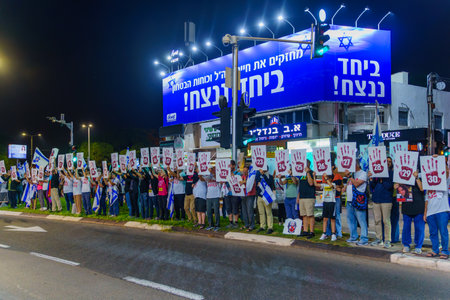 Haifa, Israel - November 11, 2023: Protest display blaming the 64 coalition members, calling for taking responsibility of the war and release of hostages. Haifa, Israelのeditorial素材