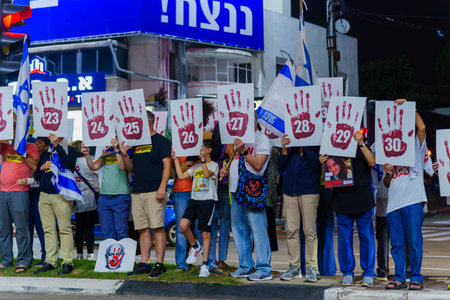 Haifa, Israel - November 11, 2023: Protest display blaming the 64 coalition members, calling for taking responsibility of the war and release of hostages. Haifa, Israelのeditorial素材