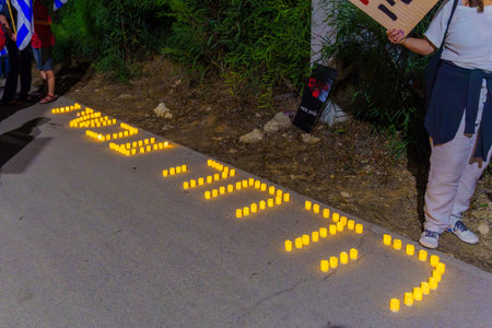 Caesarea, Israel - November 11, 2023: The words impeachment now written with candles, part of a protest against the government. Caesarea, Israelのeditorial素材