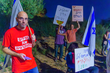 Caesarea, Israel - November 11, 2023: People protest against the prime minister Benjamin Netanyahu, calling for taking responsibility and resign. Caesarea, Israelのeditorial素材