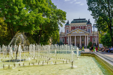 Sofia, Bulgaria - September 14, 2023: View of the city garden, with the Dancing Ballerina fountain, Ivan Vazov National Theater, Locals and Visitors, in Sofia, Bulgariaのeditorial素材
