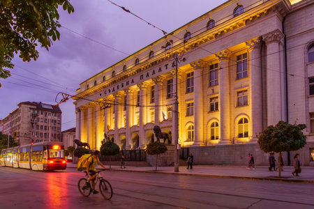 Sofia, Bulgaria - September 14, 2023: Evening view of the City Court building, with a tram, locals, and visitors, in Sofia, Bulgariaのeditorial素材
