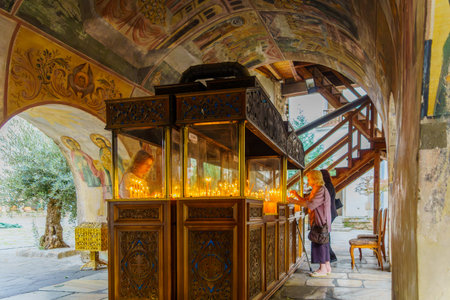 Bachkovo, Bulgaria - September 26, 2023: View of pilgrims lighting candles, in the Bachkovo Monastery of the Dormition of the Theotokos, southern Bulgariaのeditorial素材