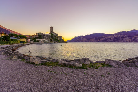 Sunset view of the fortress of Malcesine, east shore of Lake Garda, on a clear winter day, in Malcesine, Veneto, Northern Italyのeditorial素材