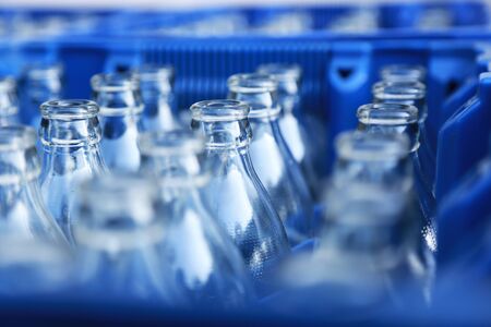 Blue Plastic Crate with Empty Glass Bottles