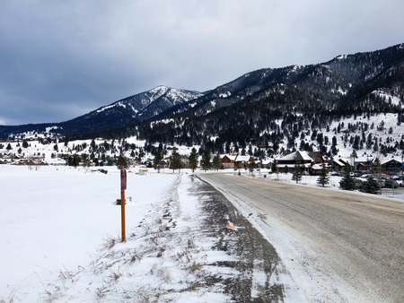 Snowy Road and Mountain Sideの写真素材