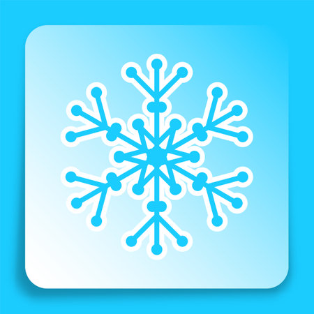 Winter snowflake icon on paper square sticker with shadow. Six pointed fluffy snowflake symbol of winter weather for mobile app. Button for mobile application or web. Vector on blue backgroundのイラスト素材