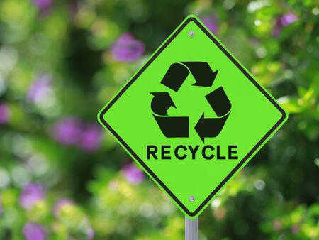 A road sign on recycling with a nature background の写真素材