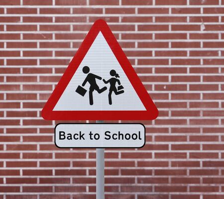 A Back To School road sign with a brick wall background の写真素材