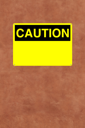 A blank caution sign mounted on a wall 