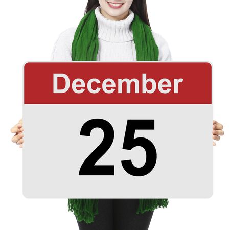 A woman holding a sign indicating December 25