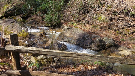 mountain stream through split rail fenceの写真素材