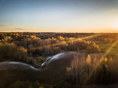 Aerial Drone Photograph of a Meadows Surrounded with Beautiful Autumn Colors of the Forestsの写真素材