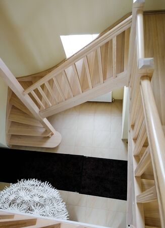 Empty Wooden Staircase with a Sunlight Shining Through the Windowの写真素材