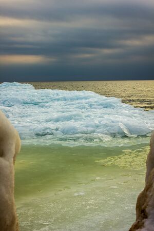 Baltic Sea Beach with Ice Floating in a Water on a Sunny Winter Dayの写真素材