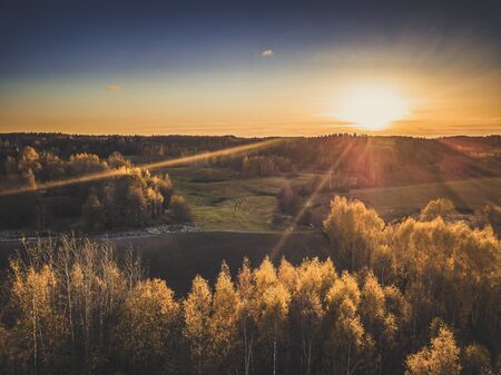 Aerial Photograph of a Meadows Surrounded with Beautiful Autumn Colors of the Forests - vintage look...