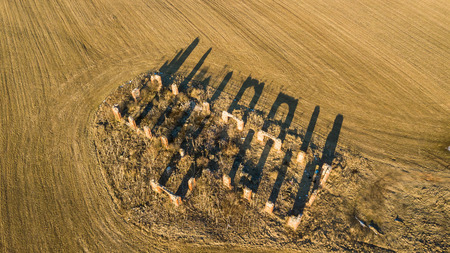 Drone photo of the ruins of an old house in countryside fields in Small Countryside Village on a Sunny Spring Dayの写真素材