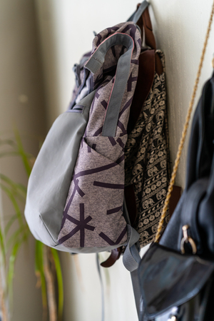 Purple School Backpack Hanging on the Wall - Isolated Object with White Backgroundの写真素材