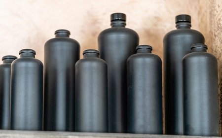 Black Bottles Standing on the Shelf - Blurred Backgroundの写真素材