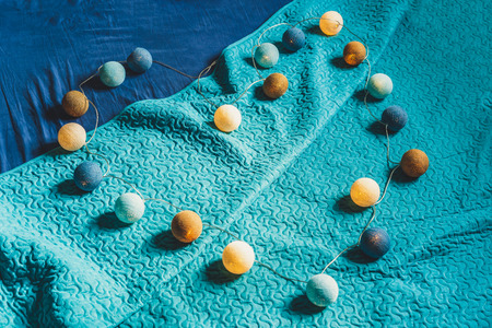 Christmas Decoration Light Balls Laying on Mattress with Turquoise Background, Heart Shape, Vintage Look Editの写真素材