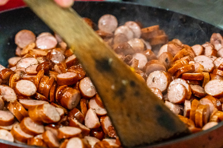 Detailed Closup Photo of Sliced Sausages Being Baked on Frying Pan - Kitchen Set