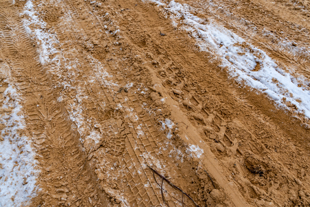 Car Tire Marks on an Empty Field Covered With Snow, closeup viewの写真素材
