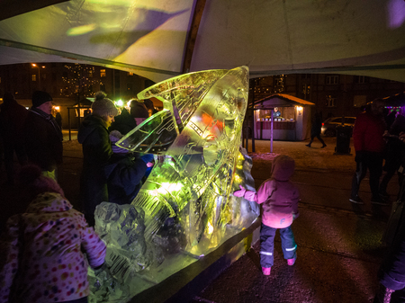 Jelgava / Latvia - February 10th, 2017: Yellow lighted fish ice sculpture at night of International Ice Sculpture Festival in Jelgava.のeditorial素材