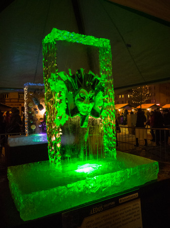 Jelgava / Latvia - February 10th, 2017: Mask frozen into ice sculpture at night of International Ice Sculpture Festival in Jelgava - green lightのeditorial素材