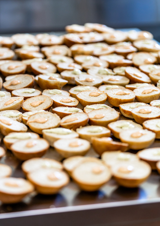 Sliced Bread Spread on a Table for Small Burgers with Ketchup and Sauce Spread over them - Kitchen Setの写真素材