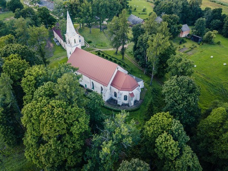 Aerial Photo of an Old Lutheran Church in Countryside Between Trees in Early Spring on Sunny Day, Close up - Concept of Harmony and Religionの写真素材