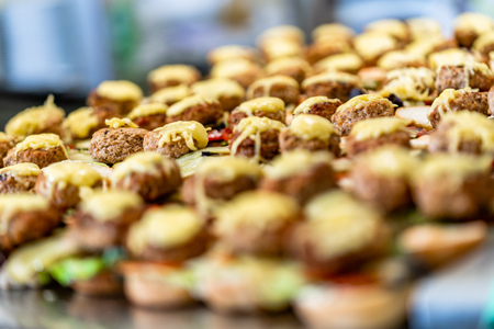 Closeup View of Sliced Bread Spread on the Table with Ingredients on them for Small Burgers - Kitchen Set, Concept of the Holiday Evening Dinner Tableの写真素材