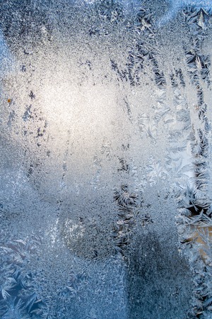 Closeup Photo of Details in Hoarfrost on Window on a Sunny Winter Day - Abstract Background with Patternの写真素材
