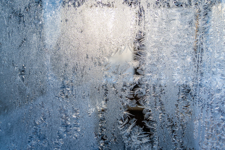 Closeup Photo of Details in Hoarfrost on Window on a Sunny Winter Day - Abstract Background with Patternの写真素材