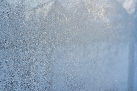 Closeup Photo of Details in Hoarfrost on Window on a Sunny Winter Day - Abstract Background with Patternの写真素材