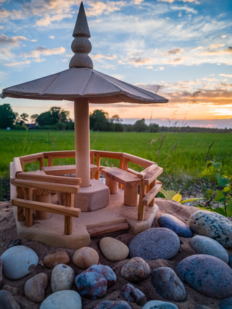 Handmade Wooden Shed Model on the Beach Sands with Stones In Front of it with Dramatic Sunset in Skies Behind it - Concept of Harmony and Peace with a Space for Textの写真素材
